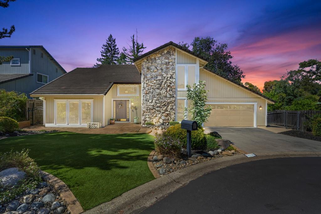 a front view of a house with a garden