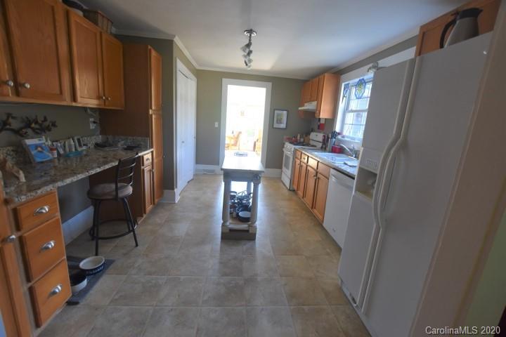294 Church Street Rutherfordton, NC 28139 - Photo 11 of 29 a kitchen with a sink stove and refrigerator