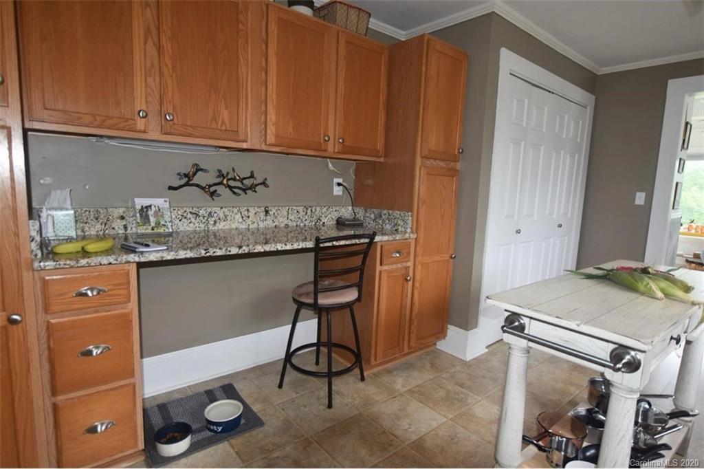 294 Church Street Rutherfordton, NC 28139 - Photo 12 of 29 a kitchen with stainless steel appliances granite countertop a sink and cabinets