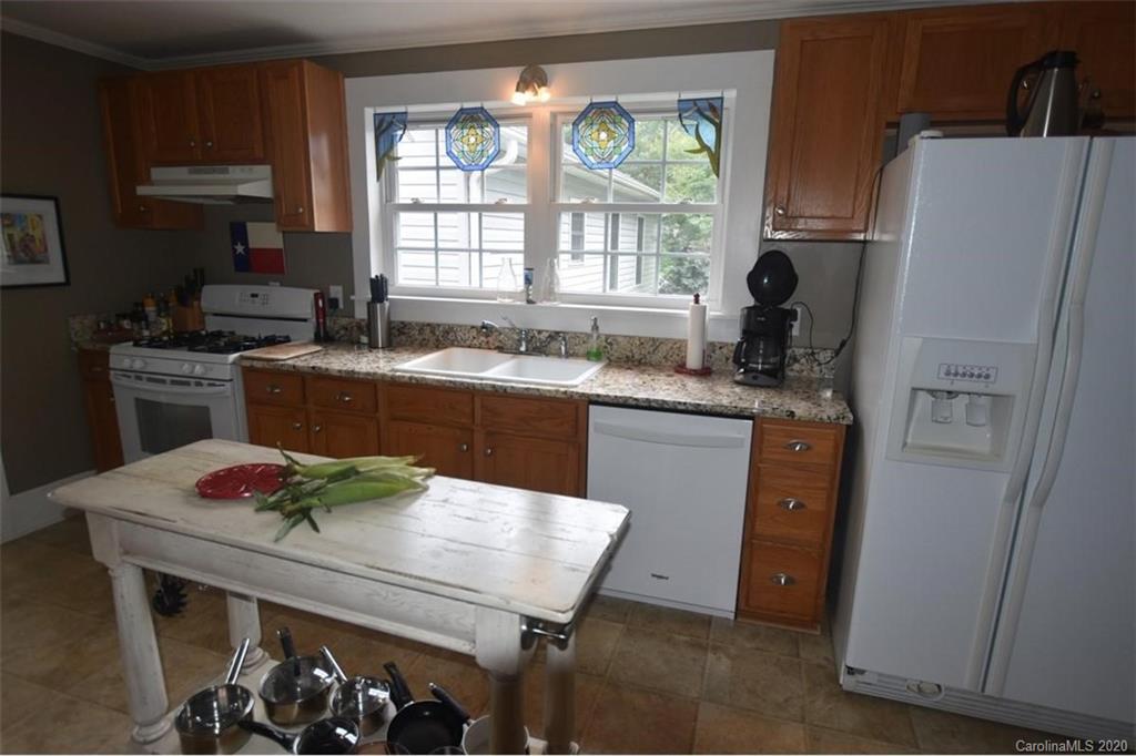 294 Church Street Rutherfordton, NC 28139 - Photo 13 of 29 a kitchen with granite countertop a sink appliances a window and dining table