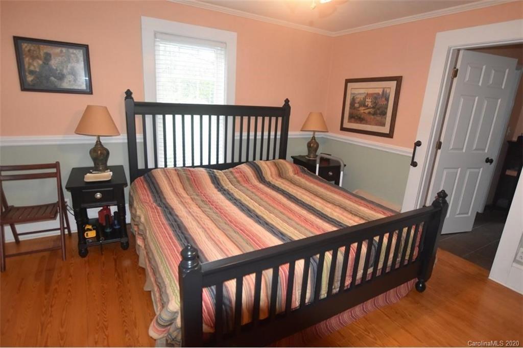 294 Church Street Rutherfordton, NC 28139 - Photo 15 of 29 a bed sitting in a bedroom next to a window