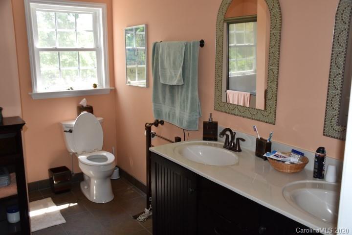 294 Church Street Rutherfordton, NC 28139 - Photo 16 of 29 a bathroom with a toilet sink and mirror