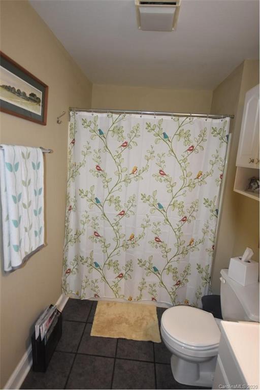 294 Church Street Rutherfordton, NC 28139 - Photo 18 of 29 a bathroom with a toilet and a shower curtain