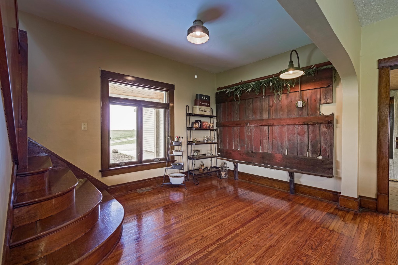 6299 Wenderoth Road Minier, IL 61759 - Photo 3 of 57 a view of an empty room with a window and wooden floor