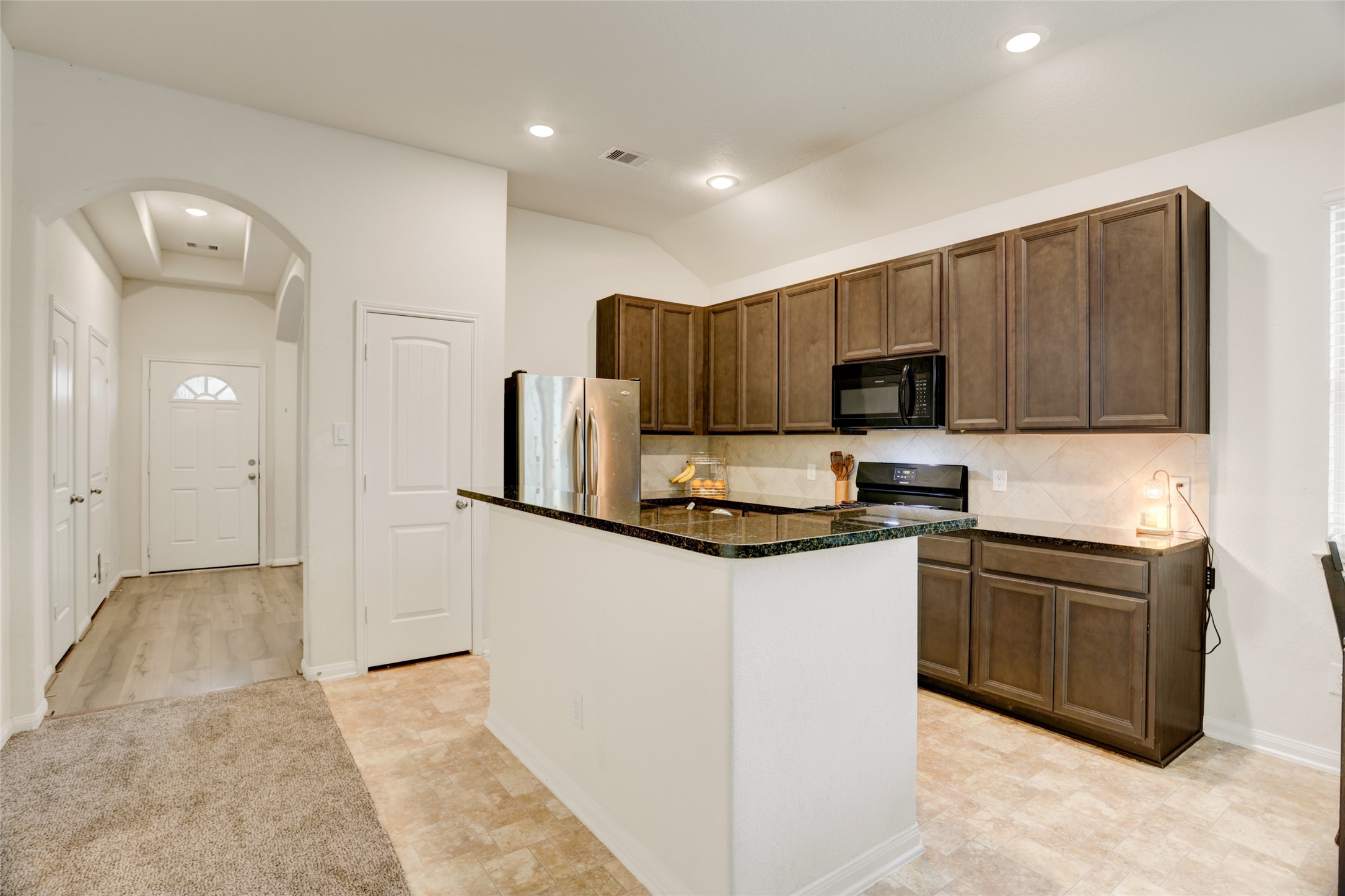 6535 Blimp Base Road Hitchcock, TX 77563 - Photo 8 of 36 The bright and airy kitchen has gorgeous cabinetry and granite counters. The neutral tile and backsplash means you can just move your things in and start cooking dinner!