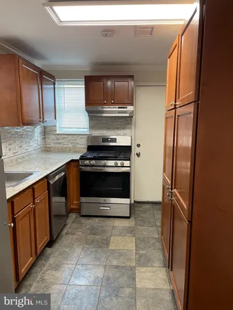 a kitchen with stainless steel appliances a stove microwave and refrigerator