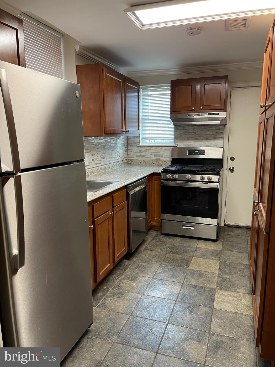 68 O Street Northwest Washington, DC 20001 - Photo 8 of 22 a kitchen with stainless steel appliances granite countertop a refrigerator a stove a sink and a microwave