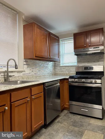 a kitchen with stainless steel appliances granite countertop a sink stove and microwave
