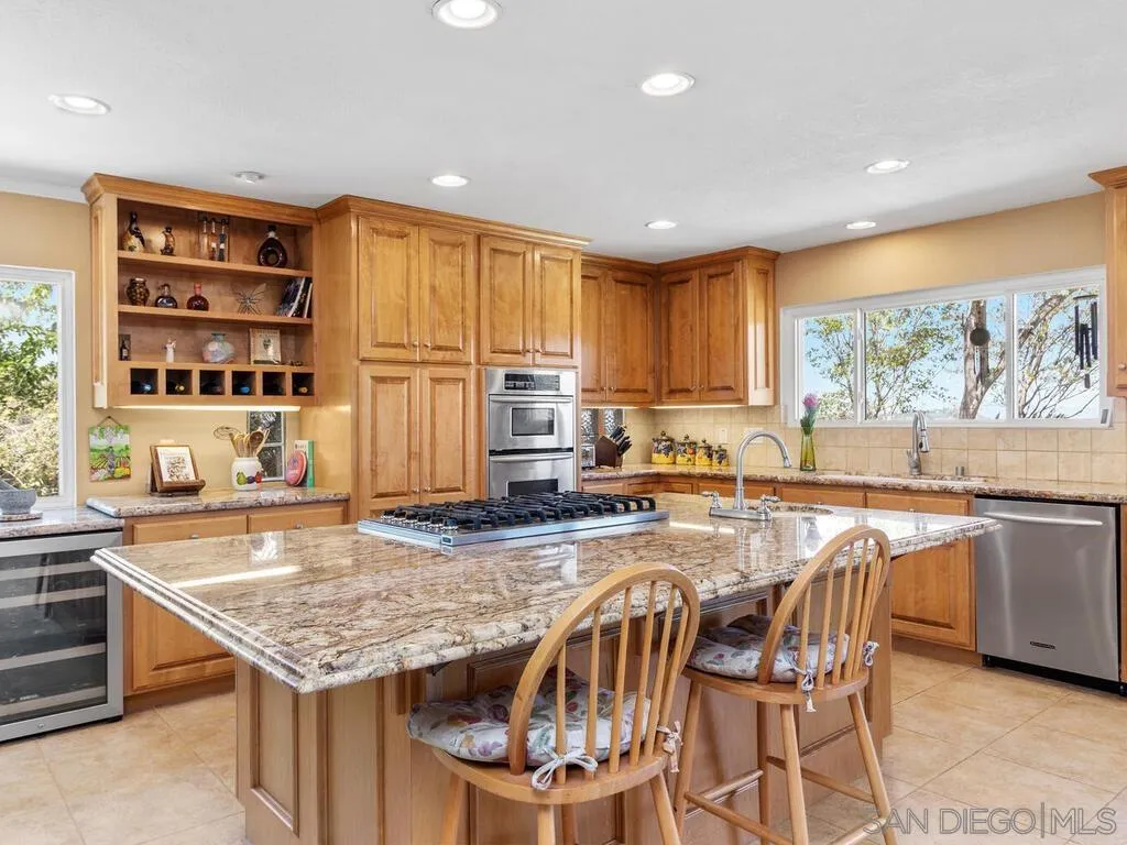 29513 Anthony Road Valley Center, CA 92082 - Photo 14 of 59 a kitchen with stainless steel appliances granite countertop a stove a sink and a refrigerator