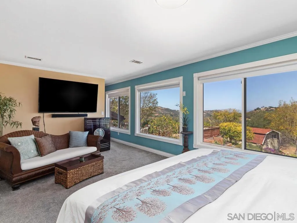 29513 Anthony Road Valley Center, CA 92082 - Photo 20 of 59 a living room with a large window and a flat screen tv