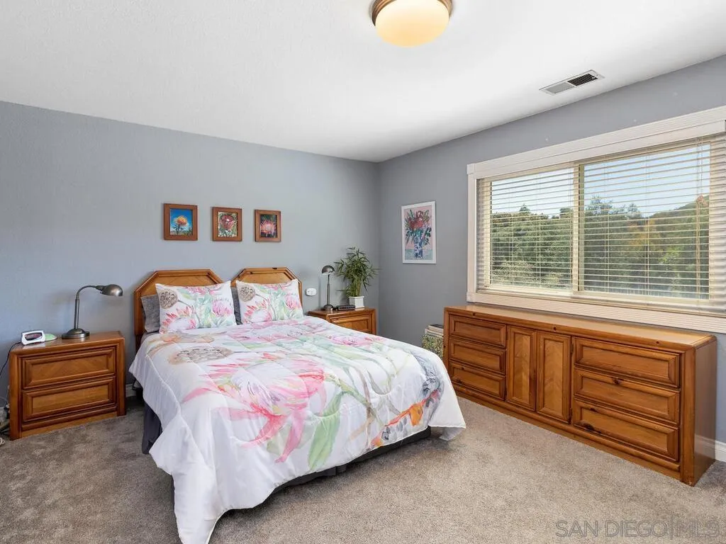 29513 Anthony Road Valley Center, CA 92082 - Photo 24 of 59 a bedroom with bed and window