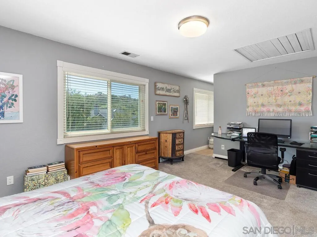29513 Anthony Road Valley Center, CA 92082 - Photo 25 of 59 a bedroom with a bed and a large window