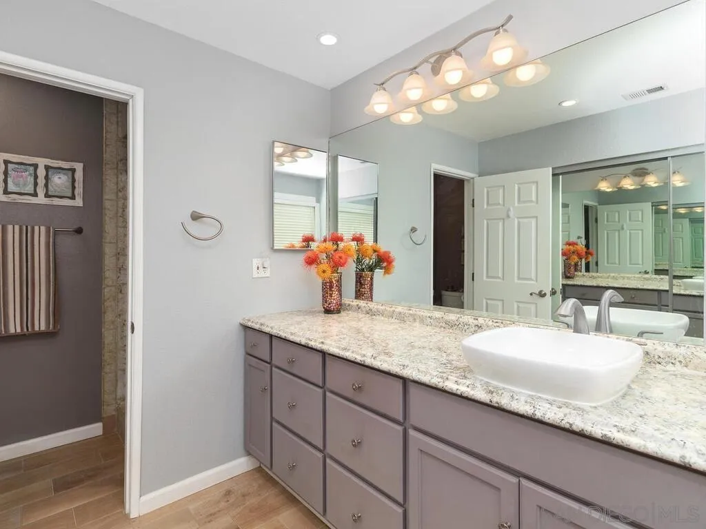 29513 Anthony Road Valley Center, CA 92082 - Photo 26 of 59 a bathroom with a granite countertop sink and a mirror