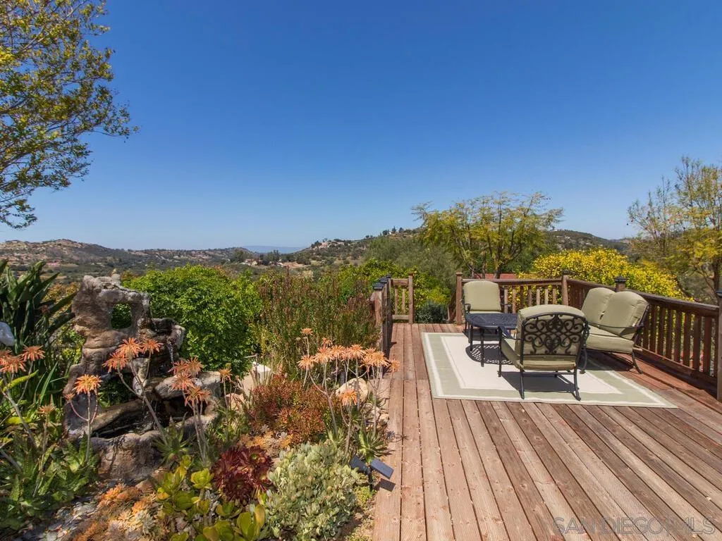29513 Anthony Road Valley Center, CA 92082 - Photo 32 of 59 a view of a balcony with two chairs and a wooden floor
