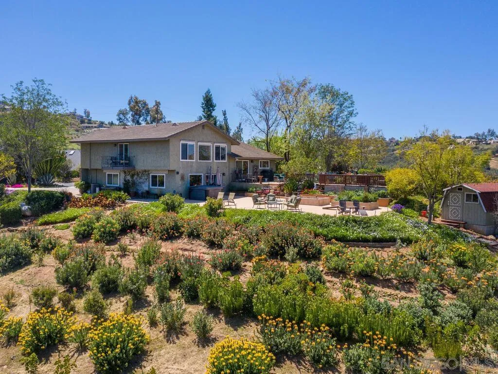 29513 Anthony Road Valley Center, CA 92082 - Photo 55 of 59 a view of a house with a big yard and potted plants