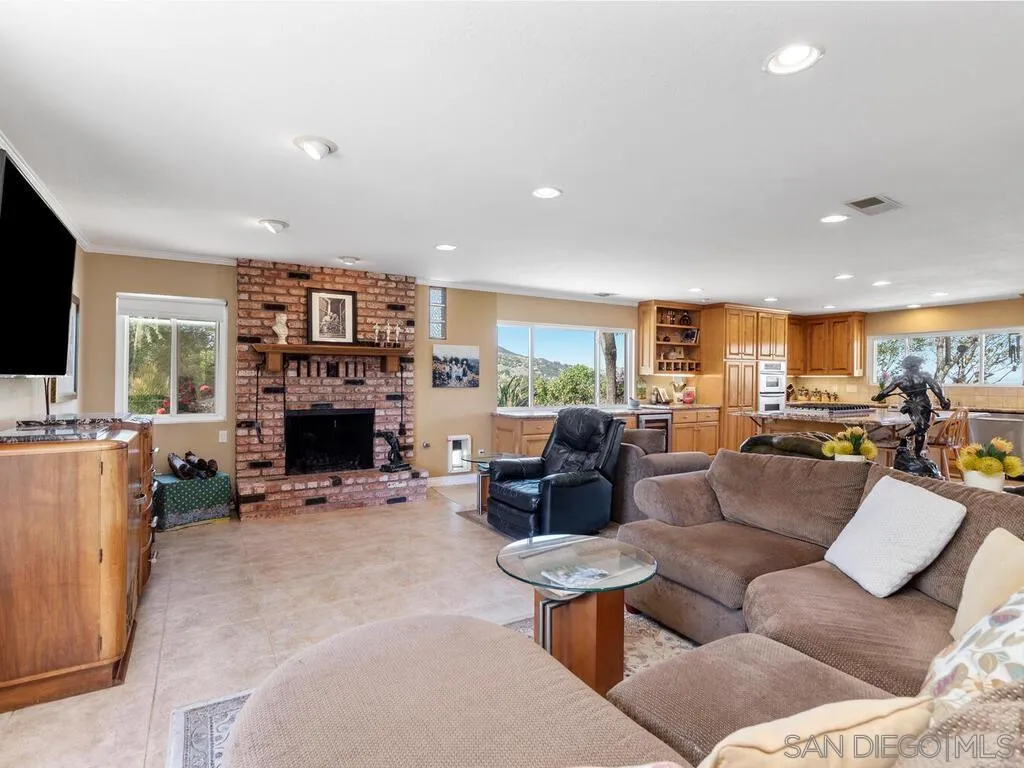 29513 Anthony Road Valley Center, CA 92082 - Photo 10 of 59 a living room with furniture a fireplace and a flat screen tv