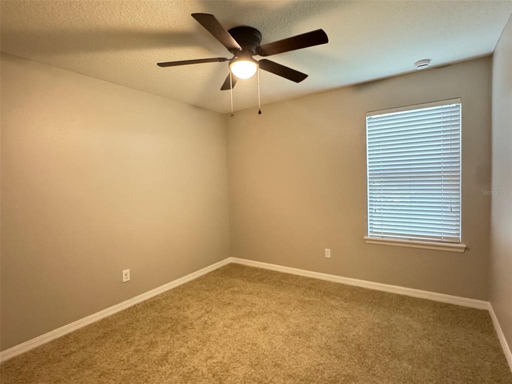 6320 Windsor Lake Circle Sanford, FL 32773 - Photo 15 of 18 an empty room with a window and a fan
