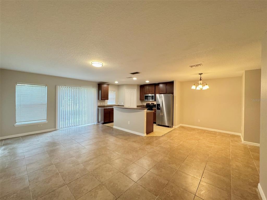 6320 Windsor Lake Circle Sanford, FL 32773 - Photo 2 of 18 a view of kitchen with kitchen island a sink a stove and white cabinets