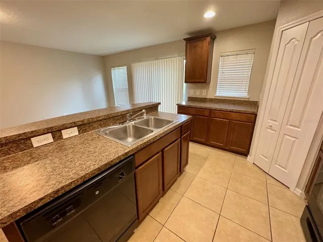 a kitchen with a sink and a stove top oven