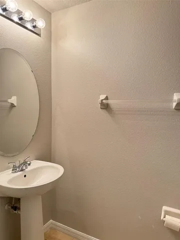 a bathroom with a sink a toilet and mirror