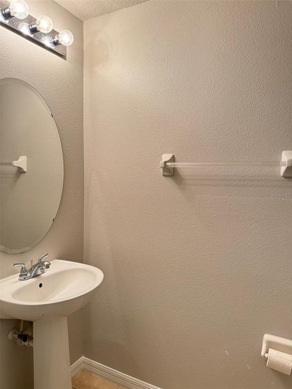 6320 Windsor Lake Circle Sanford, FL 32773 - Photo 6 of 18 a bathroom with a sink a toilet and mirror
