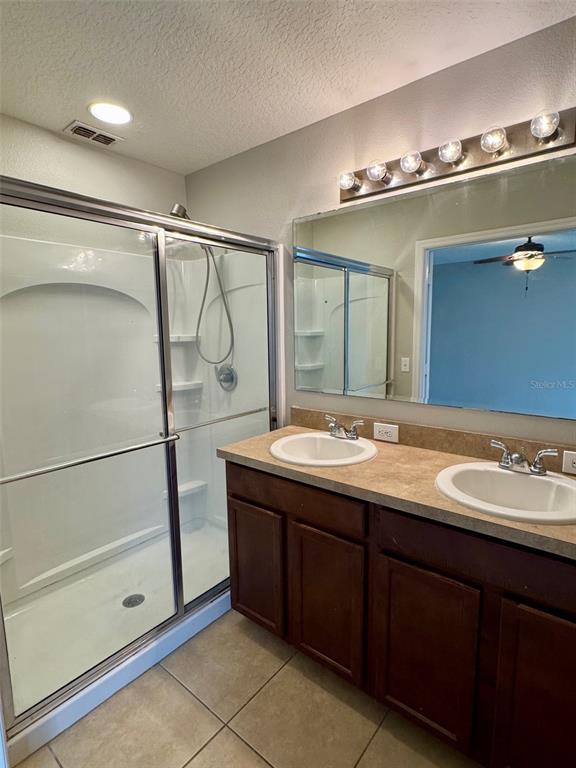 6320 Windsor Lake Circle Sanford, FL 32773 - Photo 10 of 18 a bathroom with a double vanity sink a mirror and shower