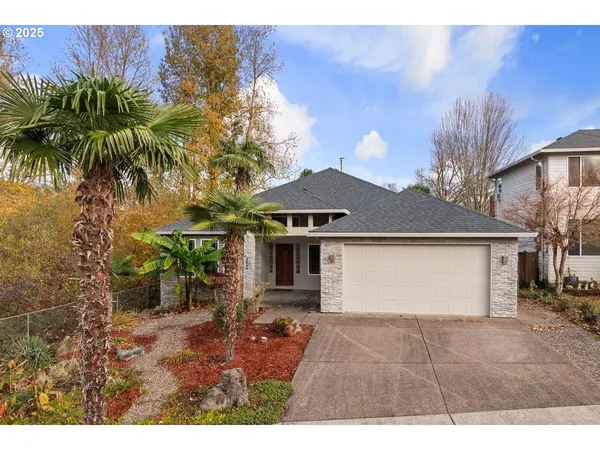 a front view of a house with a garden