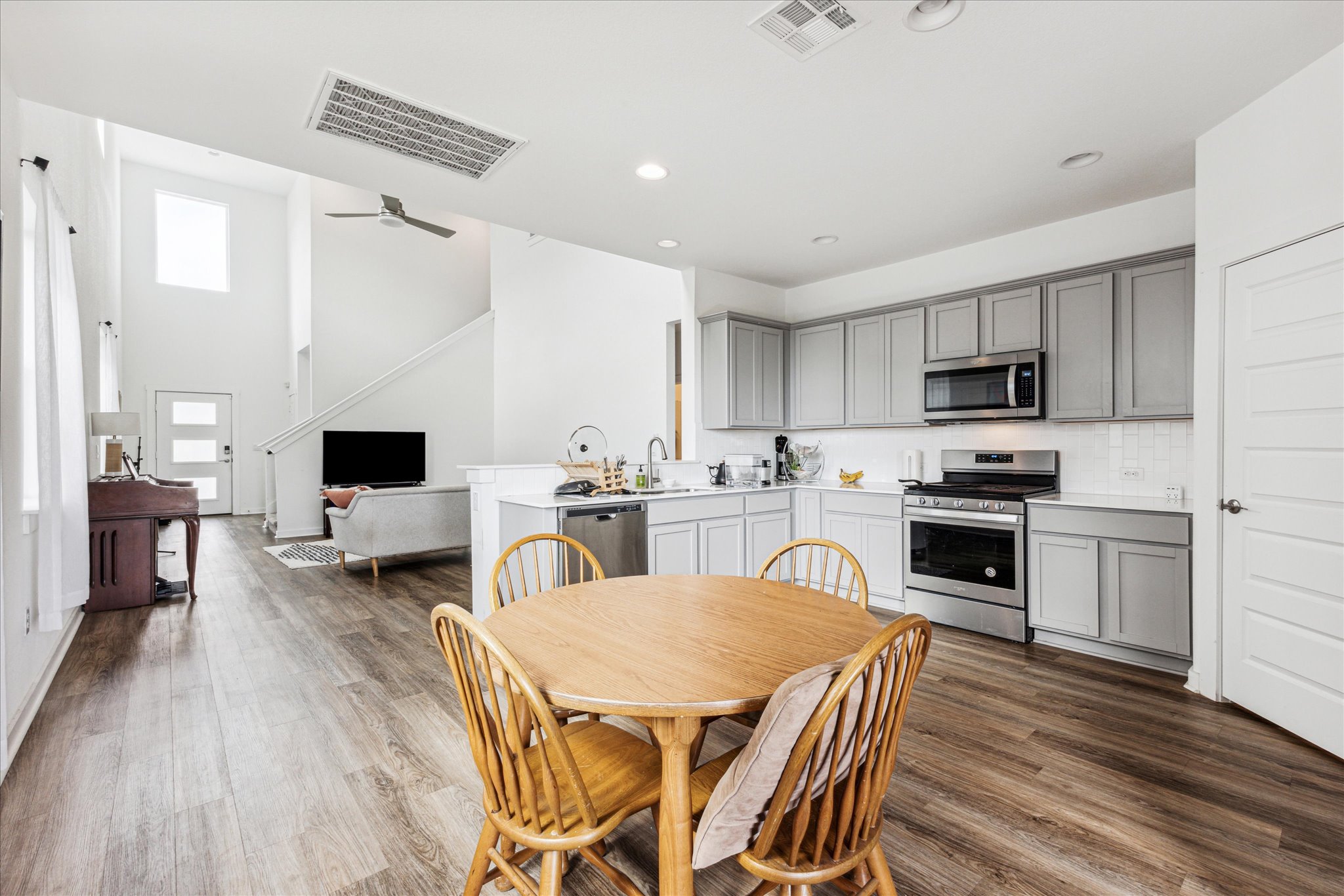 7916 Linnie Lane Austin, TX 78724 - Photo 6 of 14 a kitchen with sink microwave refrigerator dining table and chairs