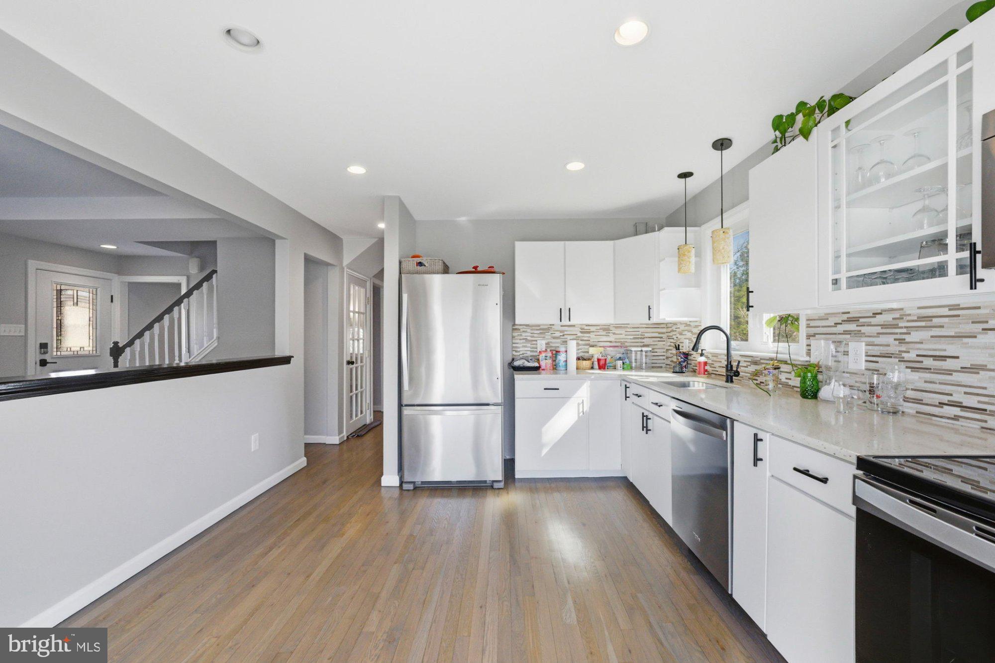 244 Manor Boulevard Hamilton, NJ 08620 - Photo 11 of 42 a kitchen with sink a refrigerator and white cabinets