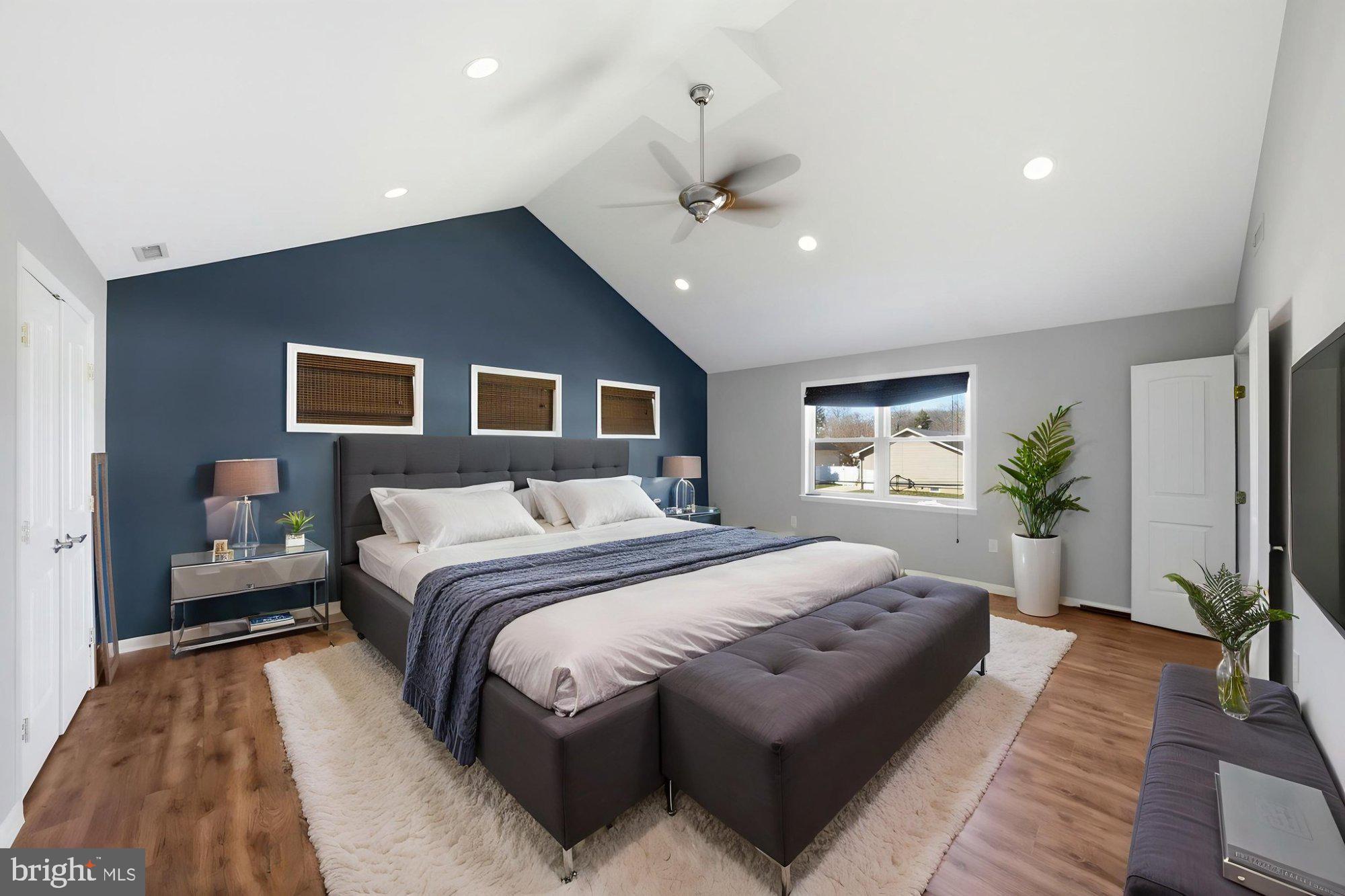 244 Manor Boulevard Hamilton, NJ 08620 - Photo 13 of 42 a spacious bedroom with a large bed and a chandelier