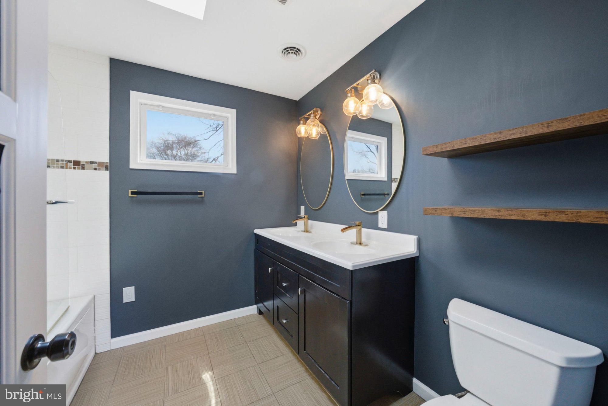 244 Manor Boulevard Hamilton, NJ 08620 - Photo 16 of 42 a bathroom with a toilet sink and mirror