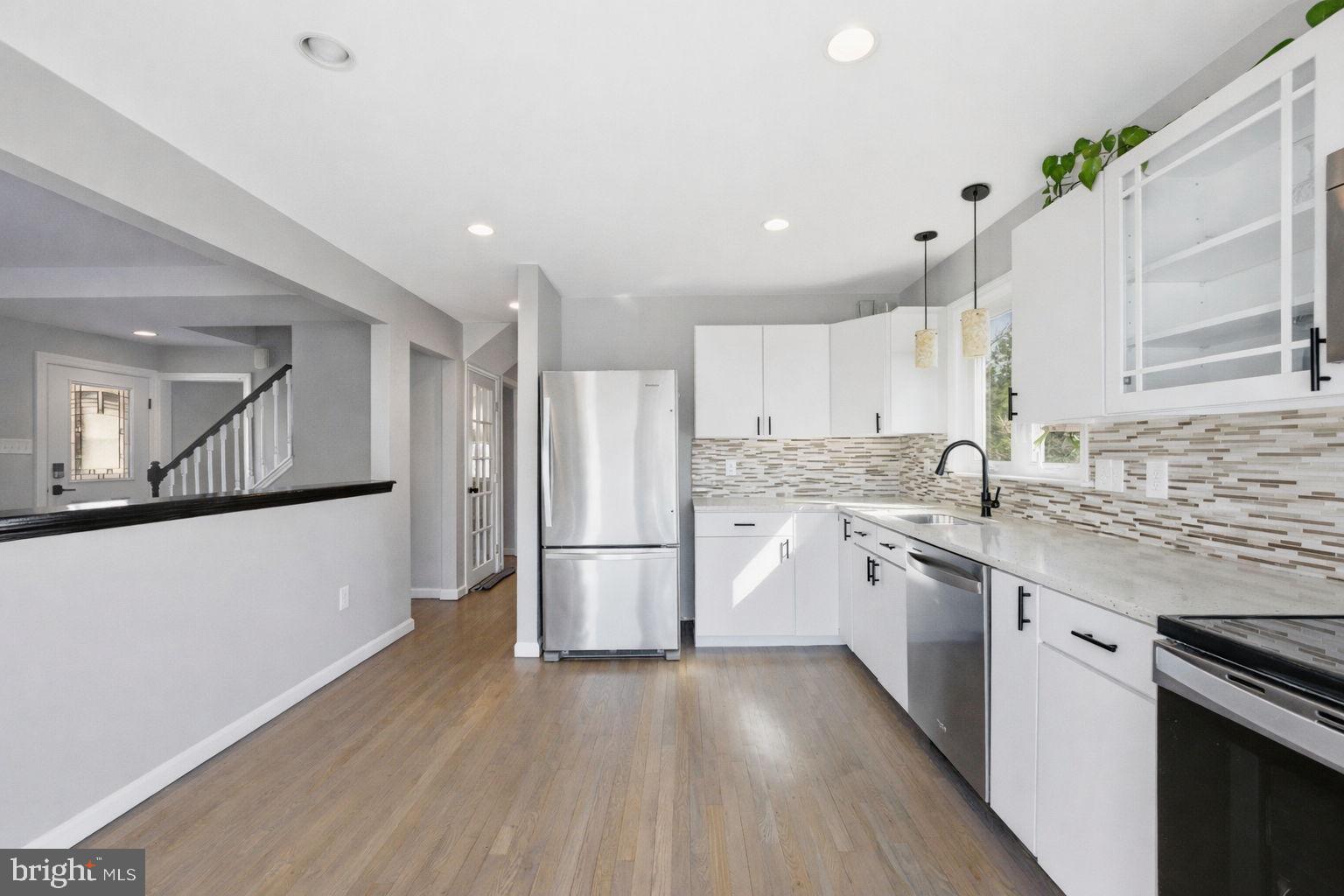 244 Manor Boulevard Hamilton, NJ 08620 - Photo 29 of 42 a kitchen with white cabinets and white appliances