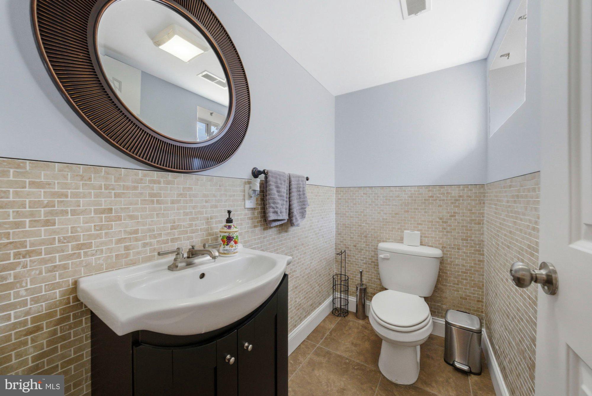 244 Manor Boulevard Hamilton, NJ 08620 - Photo 10 of 42 a bathroom with a toilet a sink and a mirror