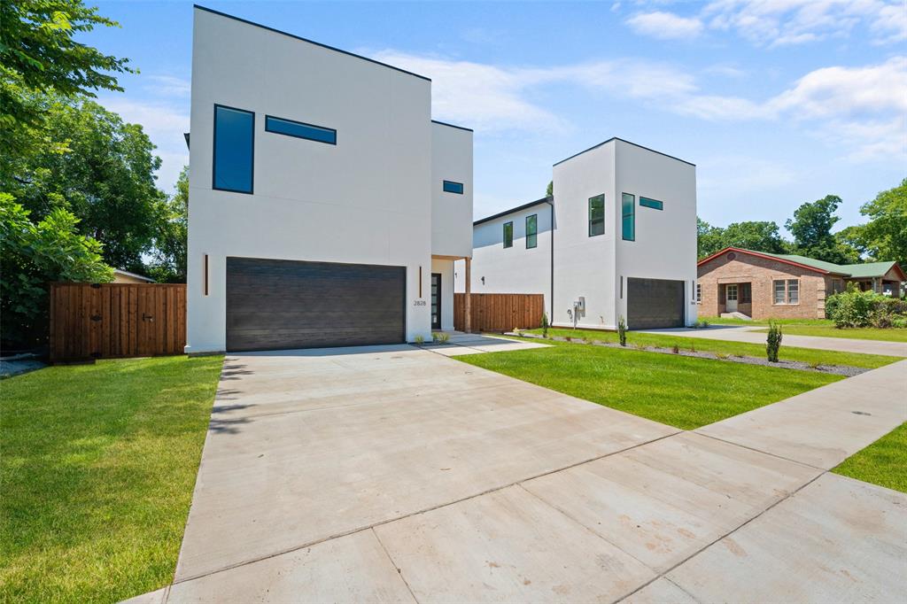 Contemporary house featuring stucco siding, a garage, and concrete driveway