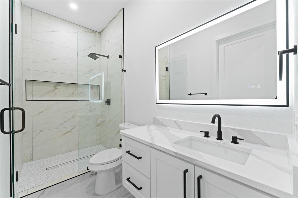 2828 Rochester Street Dallas, TX 75215 - Photo 24 of 36 Full bath featuring vanity and a marble finish shower