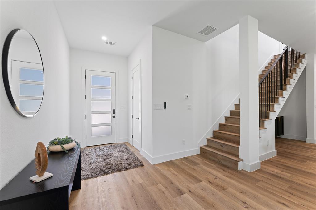 2828 Rochester Street Dallas, TX 75215 - Photo 3 of 36 Entryway featuring light wood-style floors and stairs