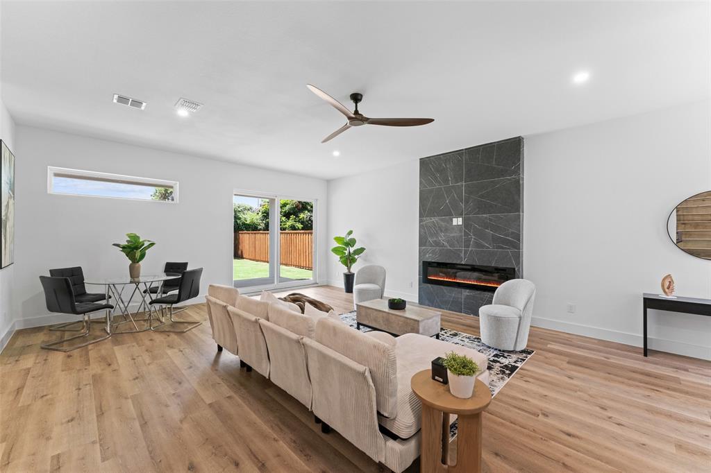 2828 Rochester Street Dallas, TX 75215 - Photo 5 of 36 Living room featuring a premium fireplace, a ceiling fan, light wood-style floors, and recessed lighting