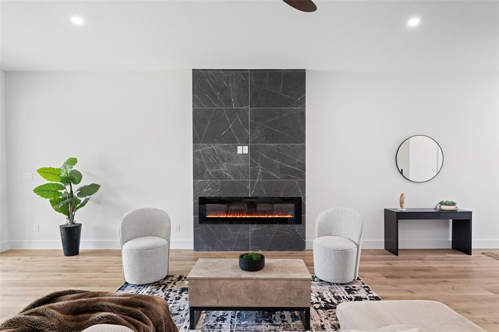 2828 Rochester Street Dallas, TX 75215 - Photo 6 of 36 Living area with a tiled fireplace, recessed lighting, and light wood-type flooring