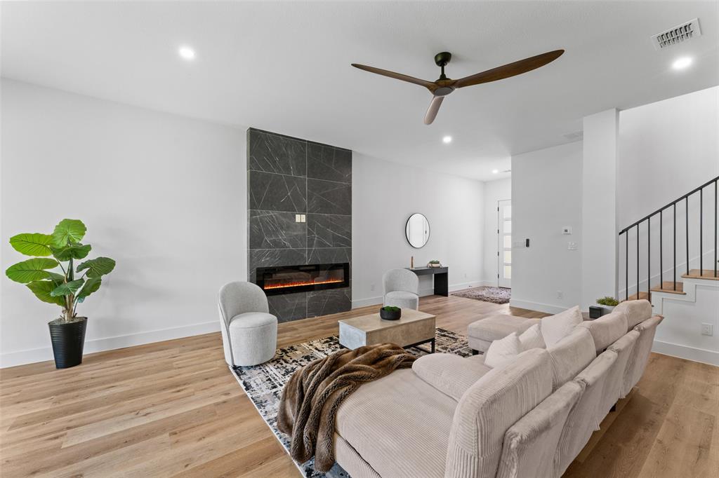 2828 Rochester Street Dallas, TX 75215 - Photo 7 of 36 Living room featuring a high end fireplace, light wood-type flooring, ceiling fan, stairs, and recessed lighting