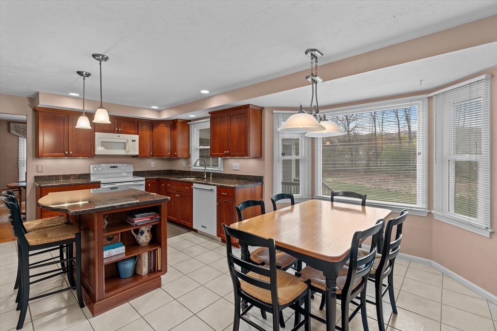 52 Pitt Road Framingham, MA 01701 - Photo 11 of 41 a kitchen with a dining table chairs sink and cabinets
