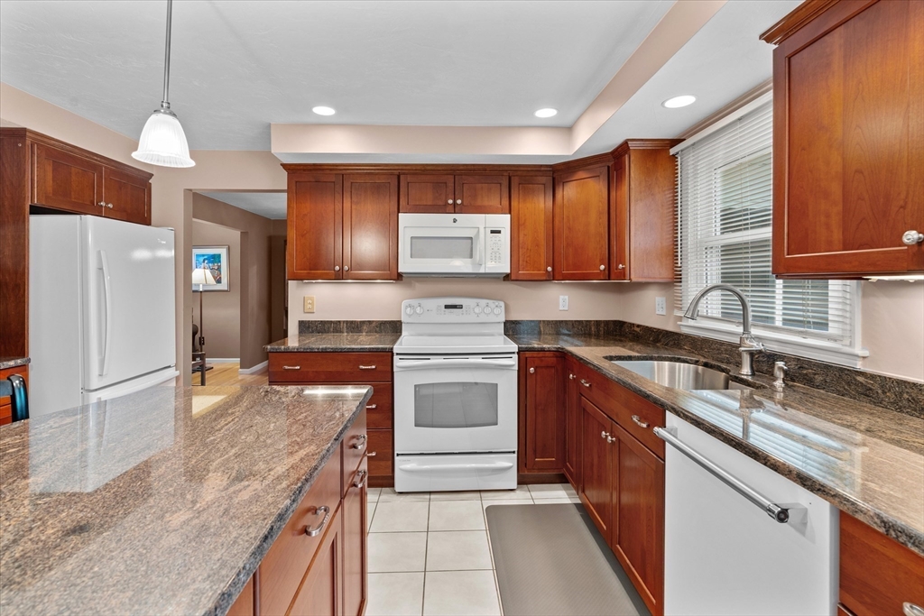 52 Pitt Road Framingham, MA 01701 - Photo 14 of 41 a kitchen with stainless steel appliances granite countertop a sink stove and refrigerator