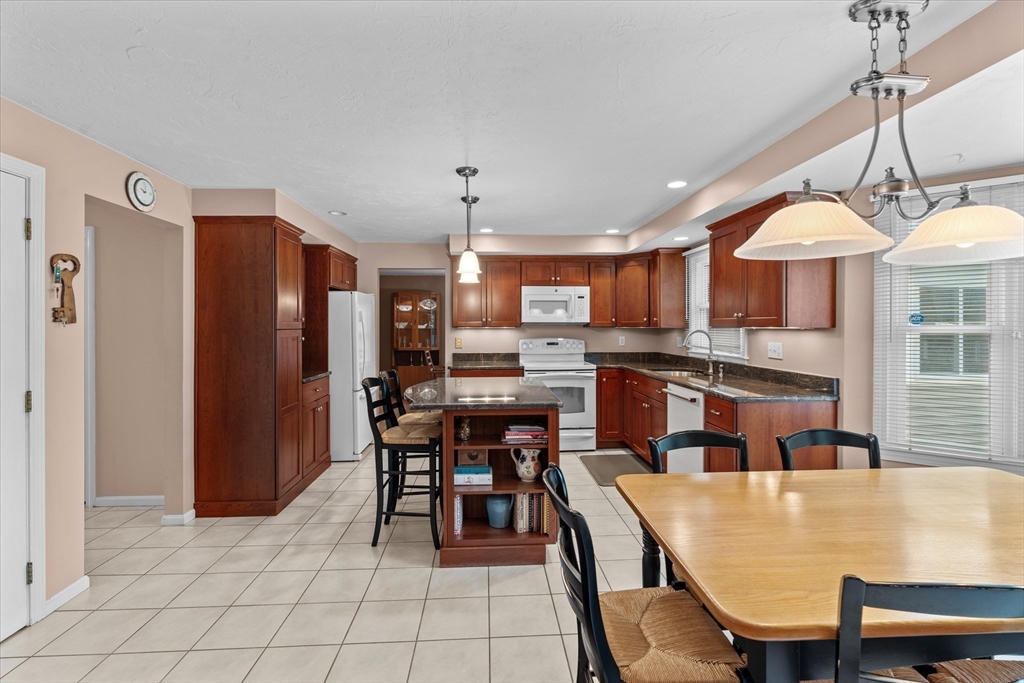 52 Pitt Road Framingham, MA 01701 - Photo 17 of 41 a large kitchen with a table and chairs