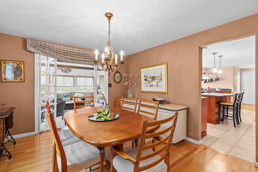 52 Pitt Road Framingham, MA 01701 - Photo 25 of 41 a view of a dining room with furniture a chandelier and wooden floor