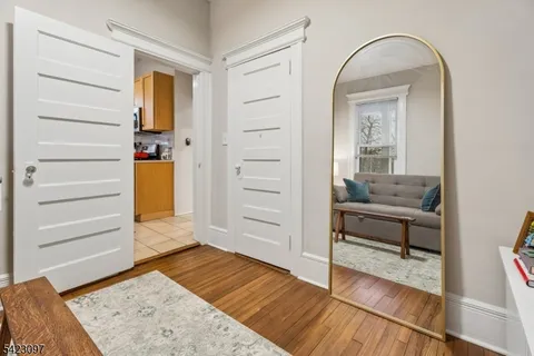 a bathroom with a toilet sink vanity and mirror