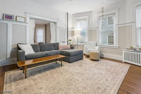 a living room with furniture and painting on the wall