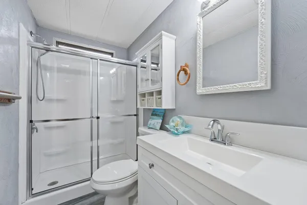 a bathroom with a sink toilet and shower