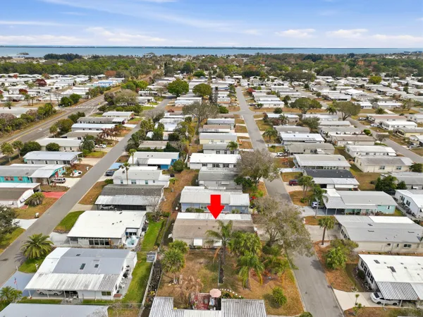 an aerial view of residential houses with city view