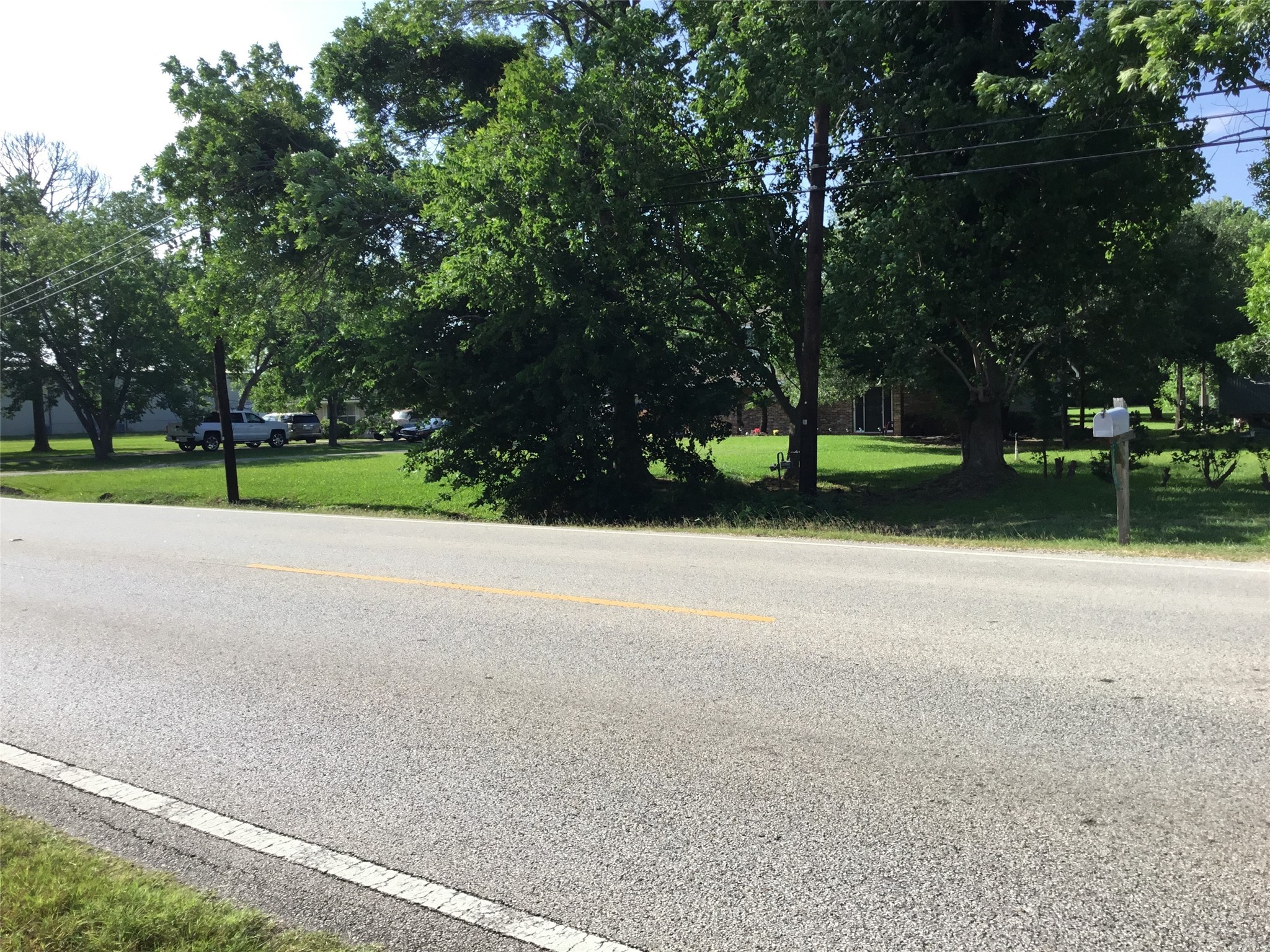 1817 West Cedar Bayou Lynchburg Road Baytown, TX 77521 - Photo 4 of 13 a view of road with large trees
