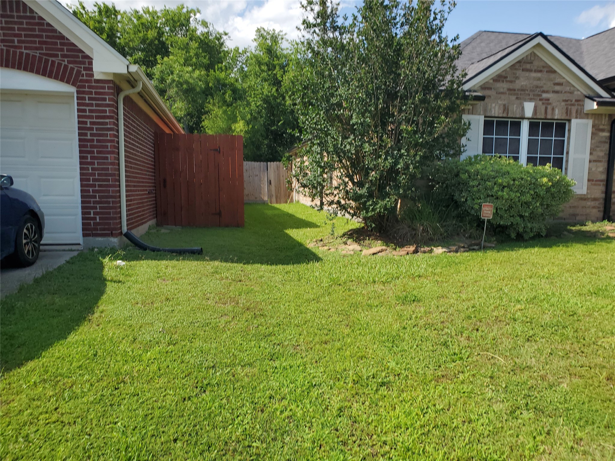 1817 West Cedar Bayou Lynchburg Road Baytown, TX 77521 - Photo 8 of 13 a front view of a house with garden