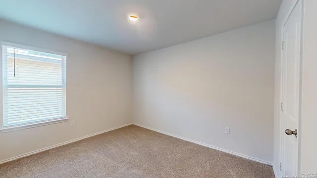 a view of an empty room and a window